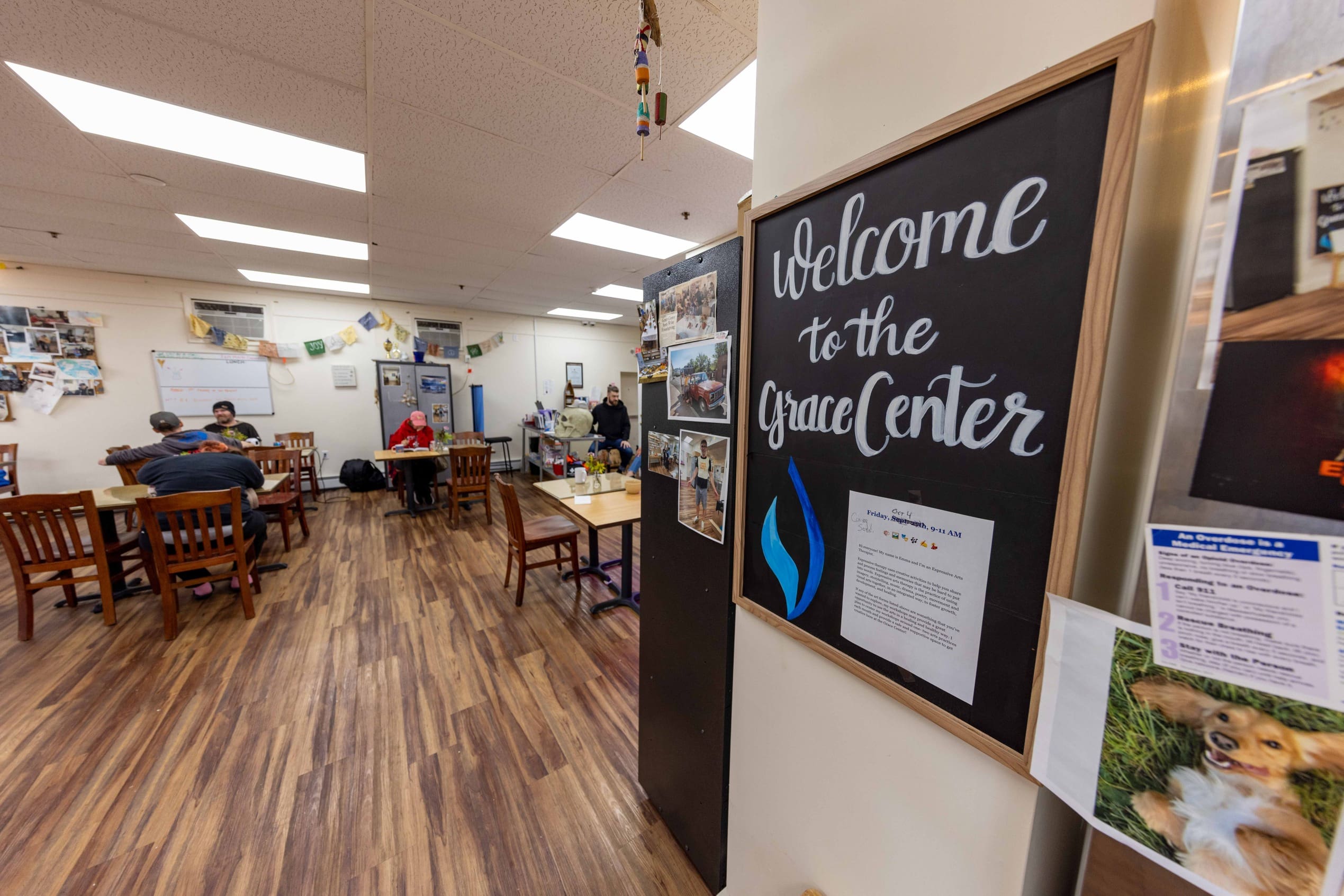 A sign reading "Welcome to the Grace Center" with the Grace Center dining room in the background.