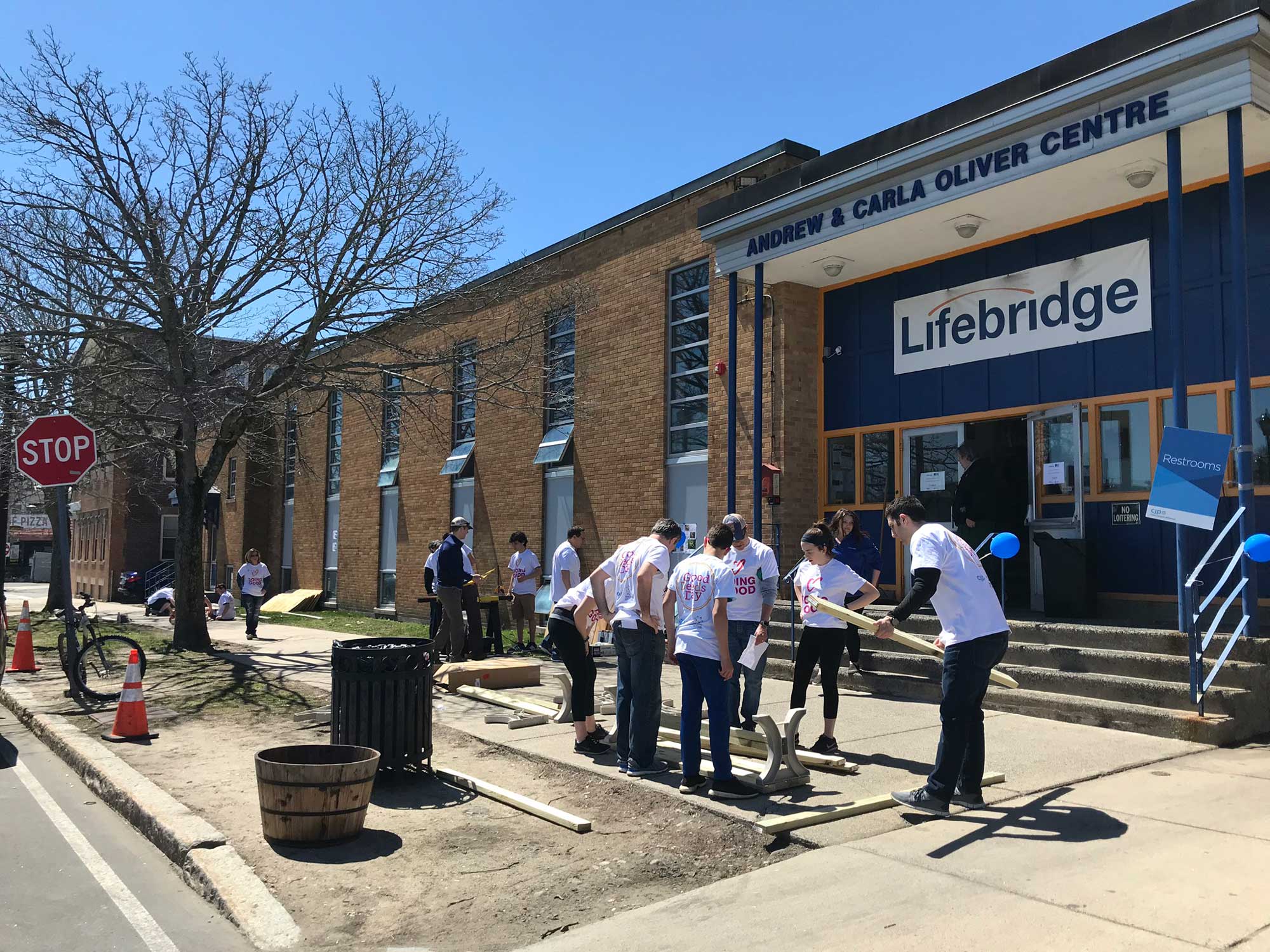 Photograph of volunteers building a bench in front of the Lifebridge main campus.