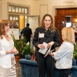 Guests talk to each other in the Hawthorne Hotel lobby at "Together for Women"