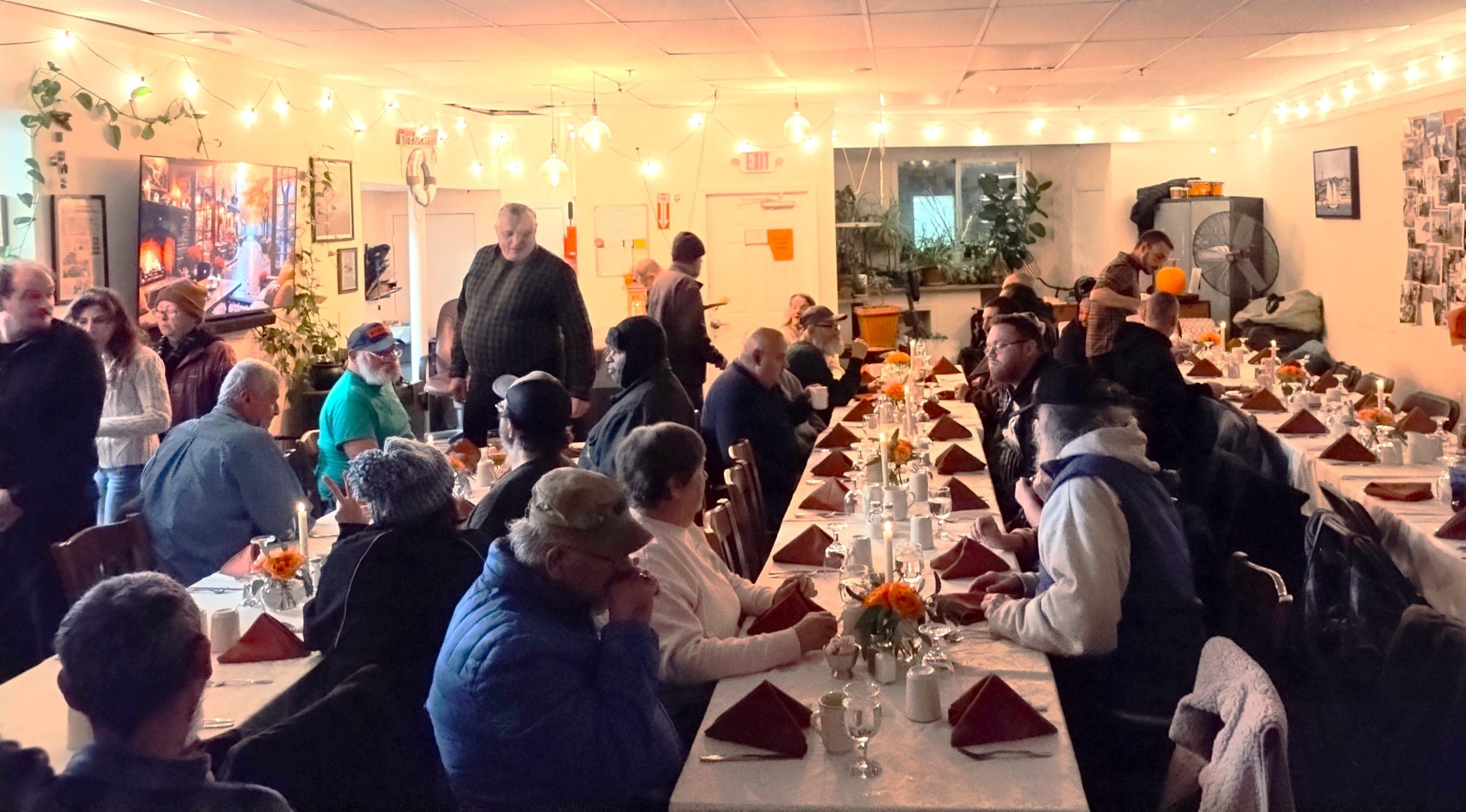 Clients, volunteers, and staff enjoy a Friendsgiving Dinner at the Grace Center in Gloucester