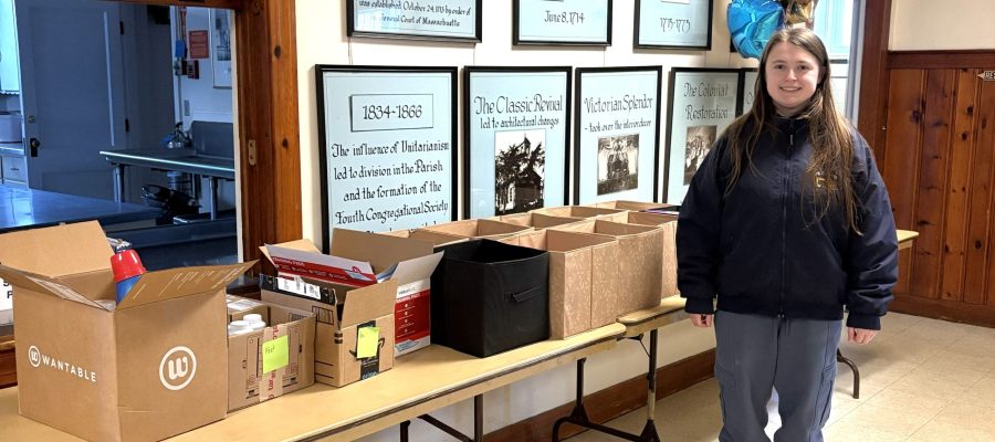 Lily Robinson, donor, stands beside items she purchased with coupons