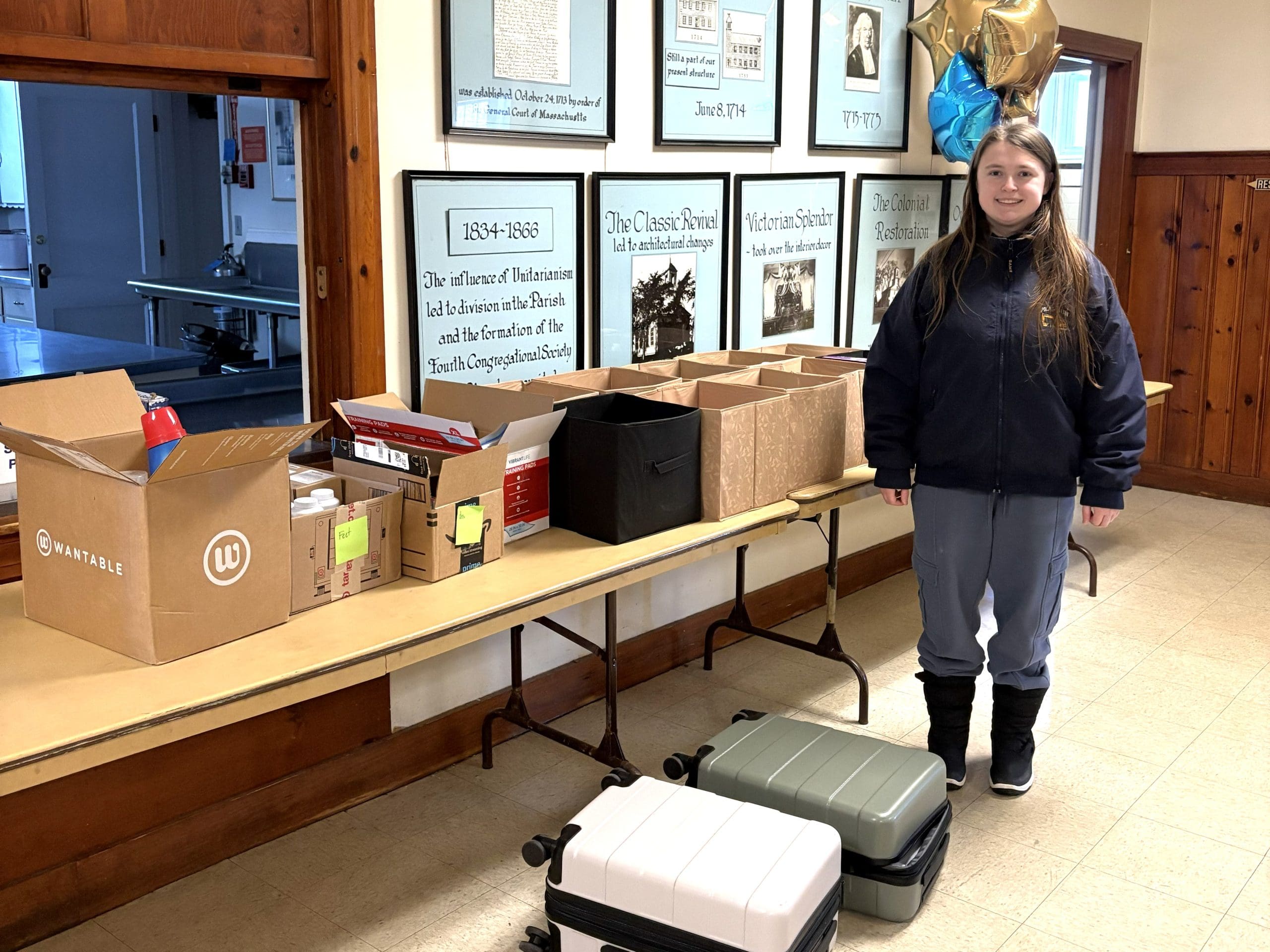 Lily Robinson, donor, stands beside items she purchased with coupons