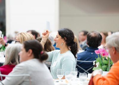 Female making a bid at auction