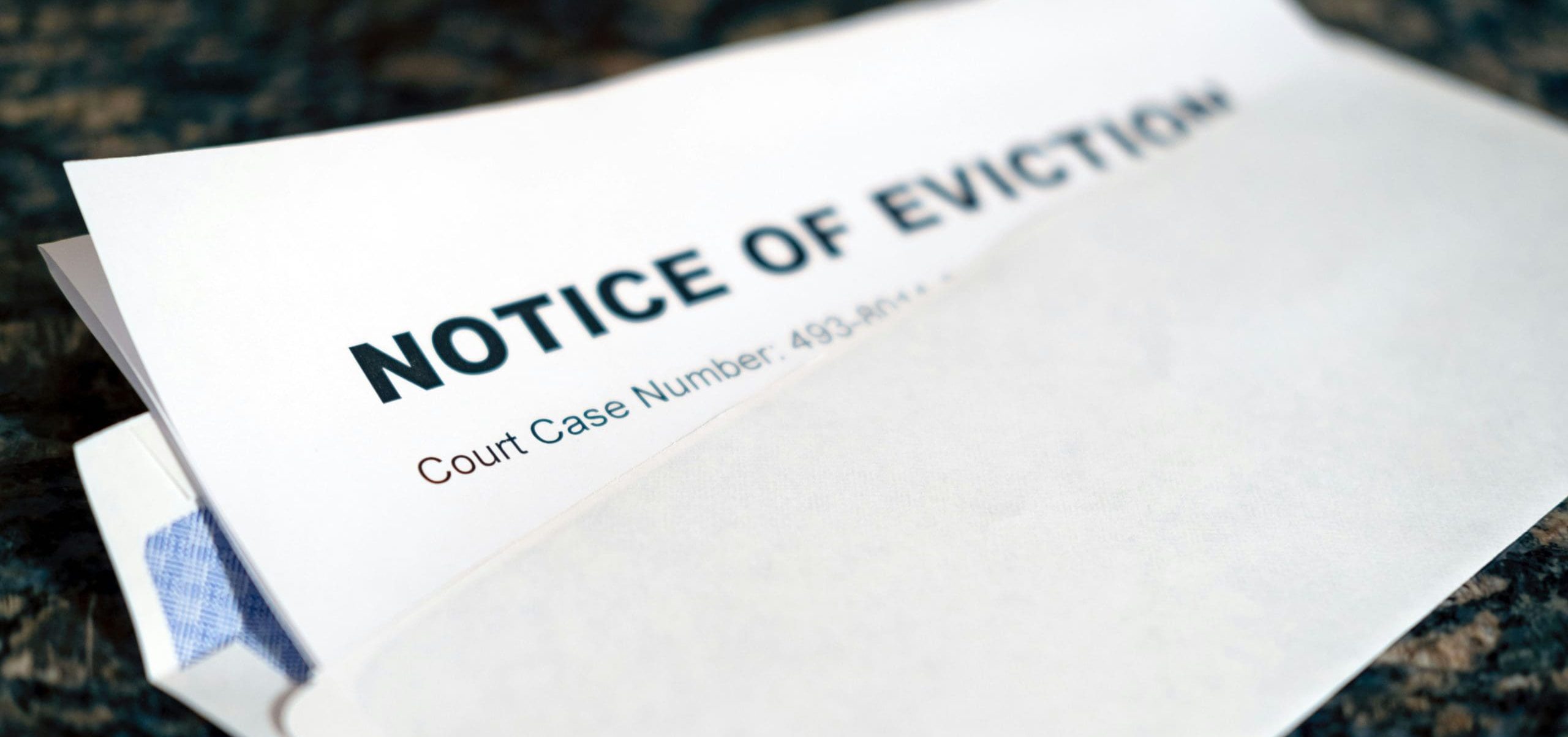 An open letter with a piece of paper that says "Notice of Eviction"